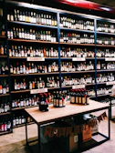 A variety of French wine bottles displayed on a wooden table.
