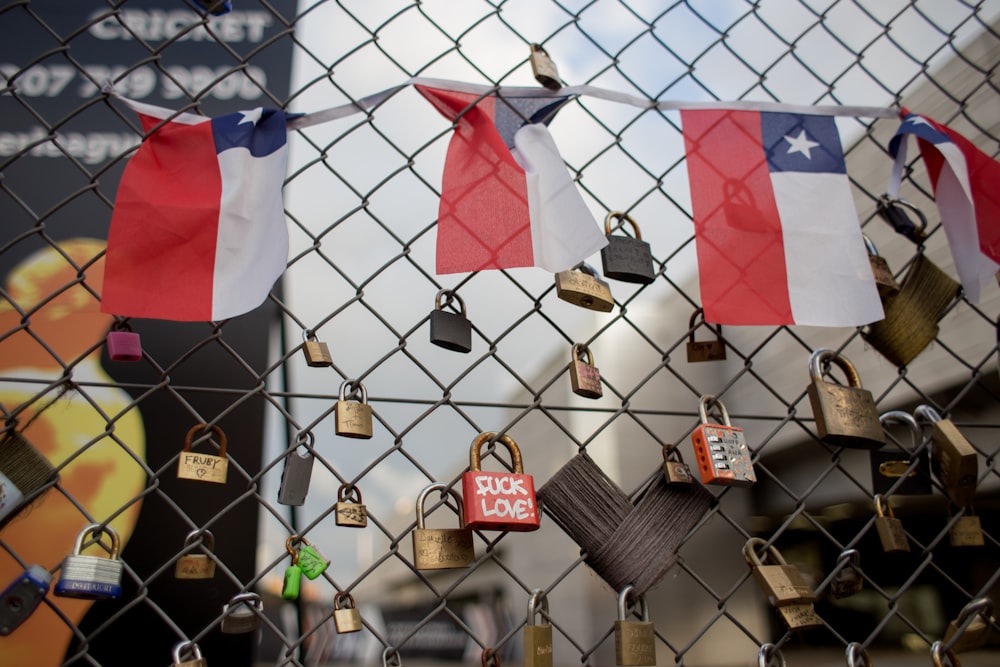Chile's flag buntings and padlocks on chain link fence