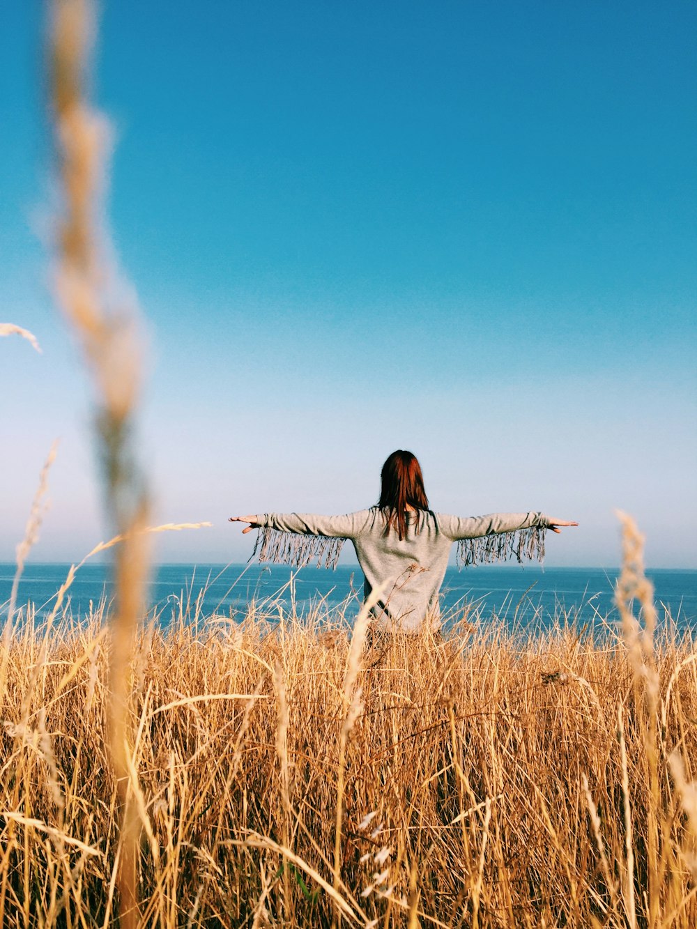 woman raising her hands outdoors