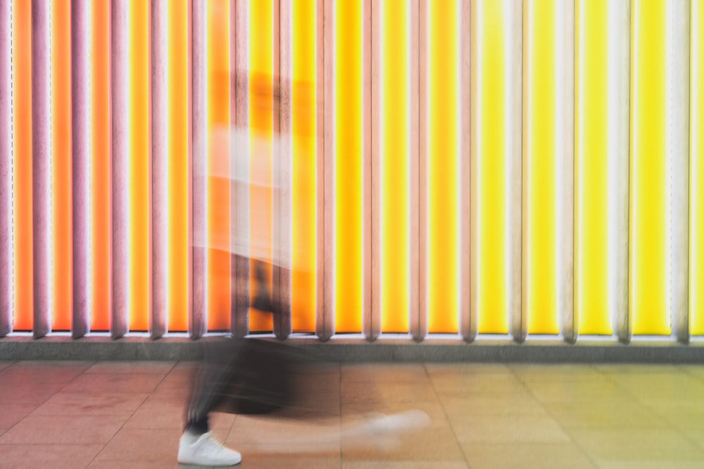person walking in front of yellow and white light