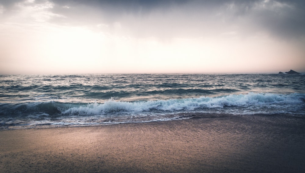 blue sea under white cloudy sky