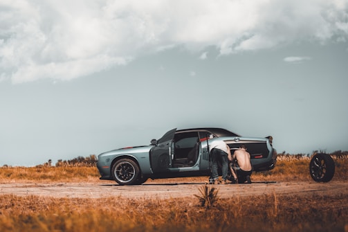 A friendly technician repairing a car windshield outdoors.