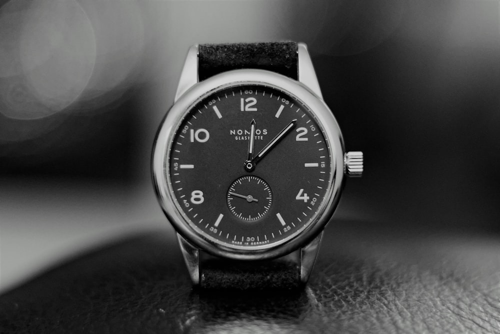 round silver-colored chronograph watch with black band