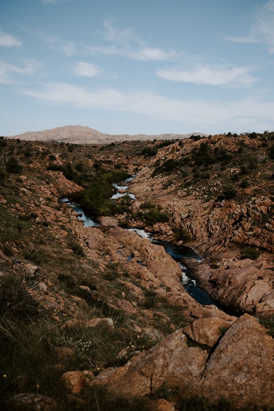 body of water surrounded by stones in Wichita Mountains United States