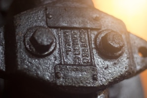 Close-up of a metal label with laser-engraved serial numbers reflecting industrial lighting