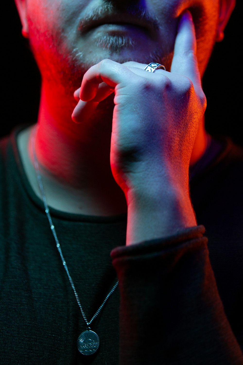 man putting his finger on chick wearing silver-colored necklace