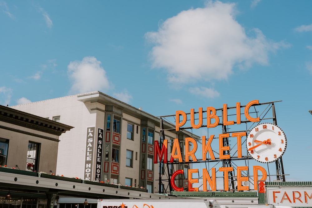 public market center neon light near white painted building