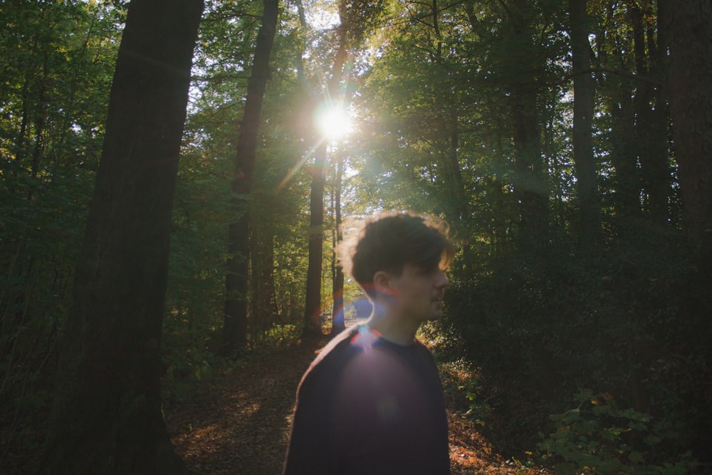 man standing inside forest