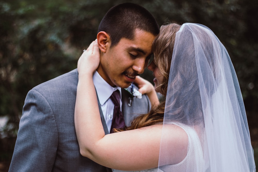 man and woman in wedding attire dancing