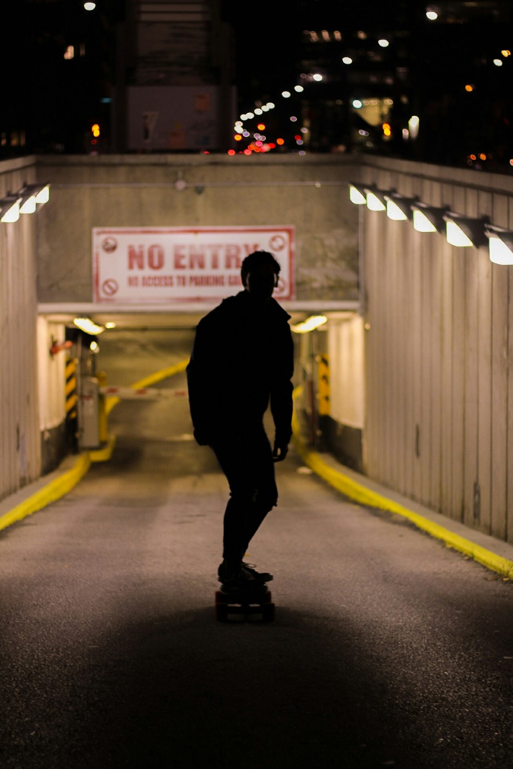 silhouette of man skating on slope street