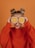 woman in red knit sweater holding lemon