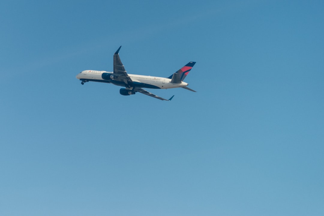 white and blue airplane in flight