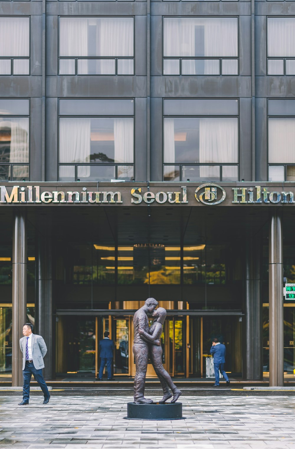 man and woman kissing statue ahead