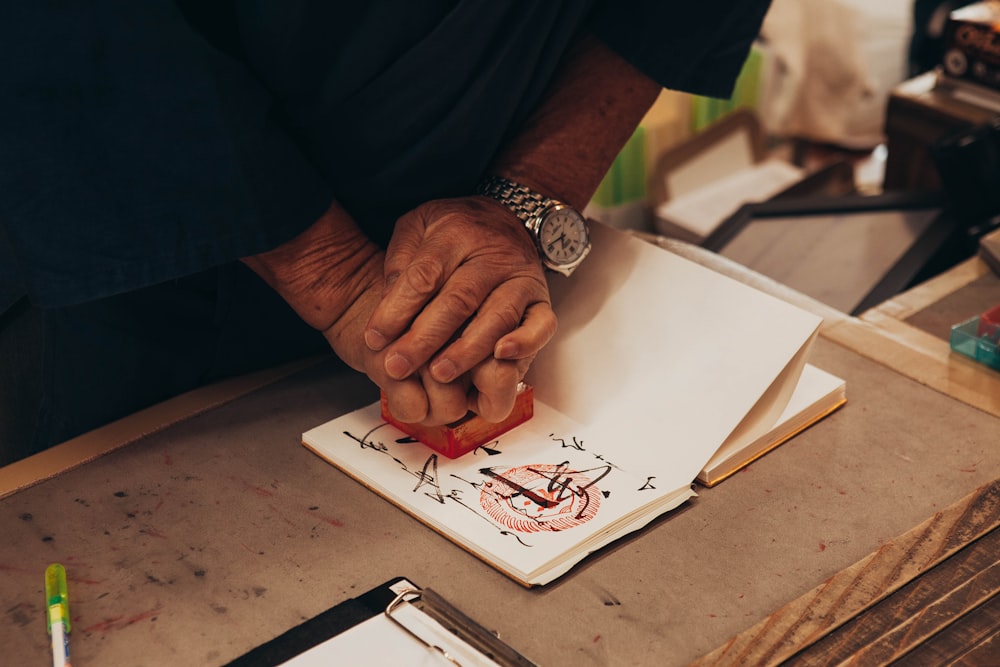 person holding pumping stamp on white paper