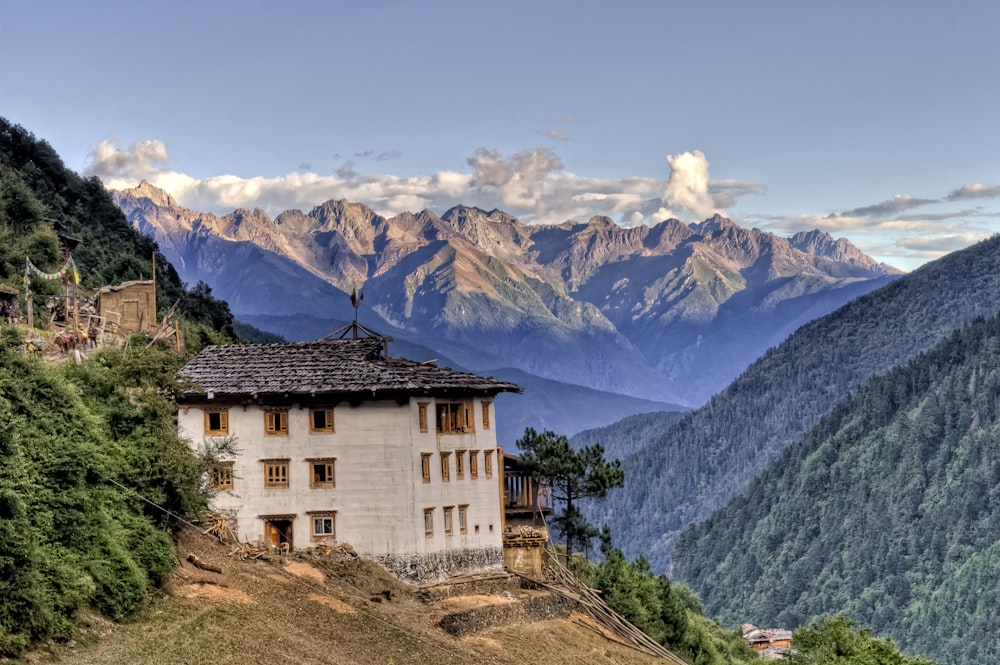 white house by mountain slope