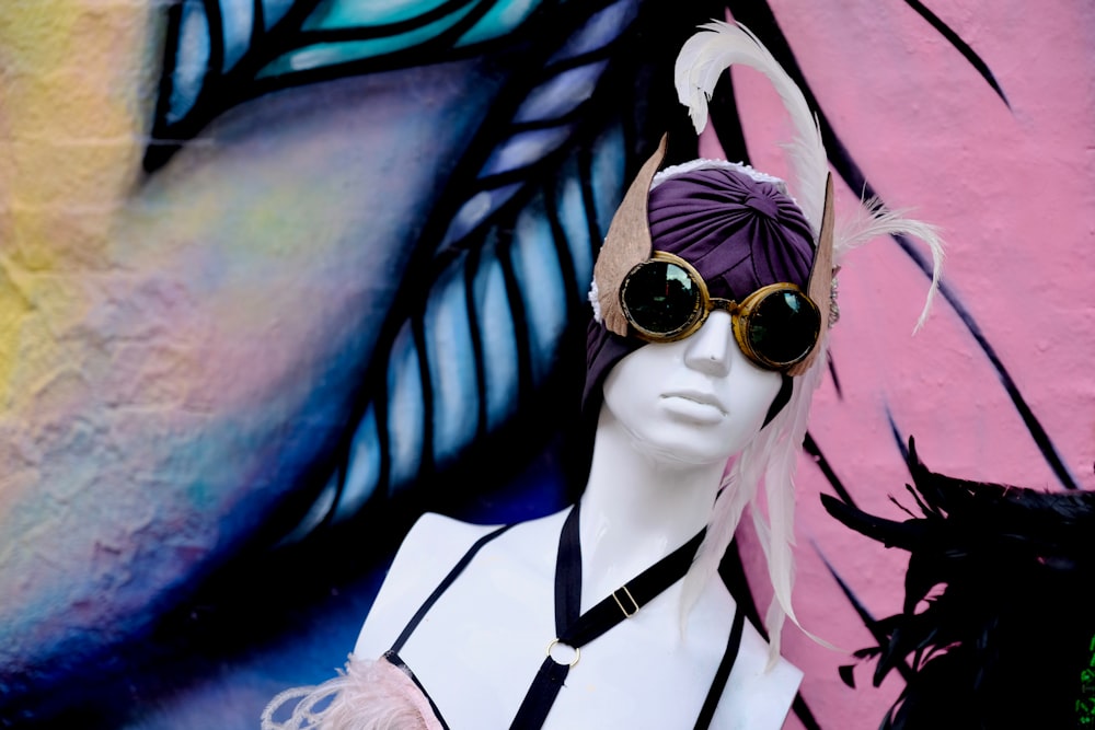 white mannequin in purple turban and brown black sunglasses