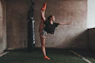 woman doing split while standing on one leg