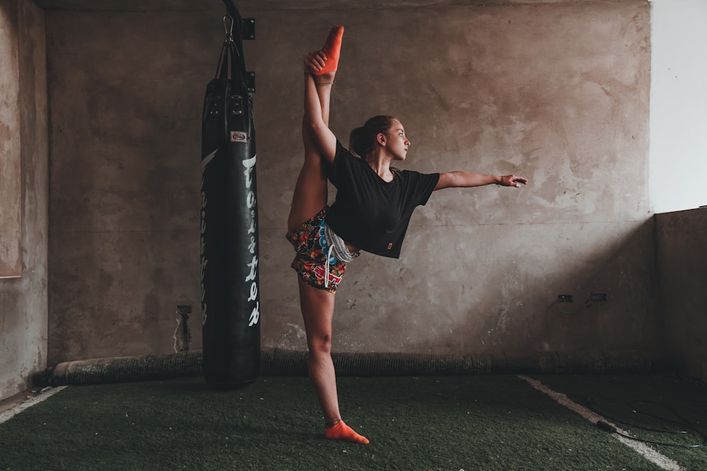 woman doing split while standing on one leg