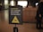 A warning sign indicating a fall hazard with instructions not to sit on railings. The sign displays a yellow warning symbol with a figure slipping off a railing.
