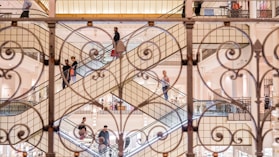 close-up photo of grill near people on escalator
