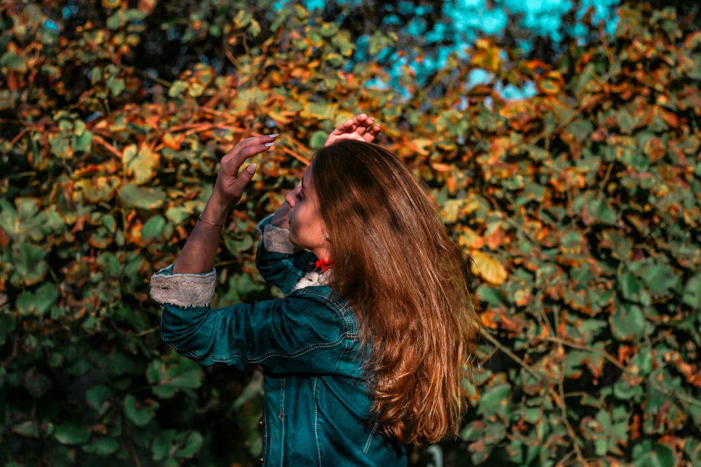 woman facing green landcape