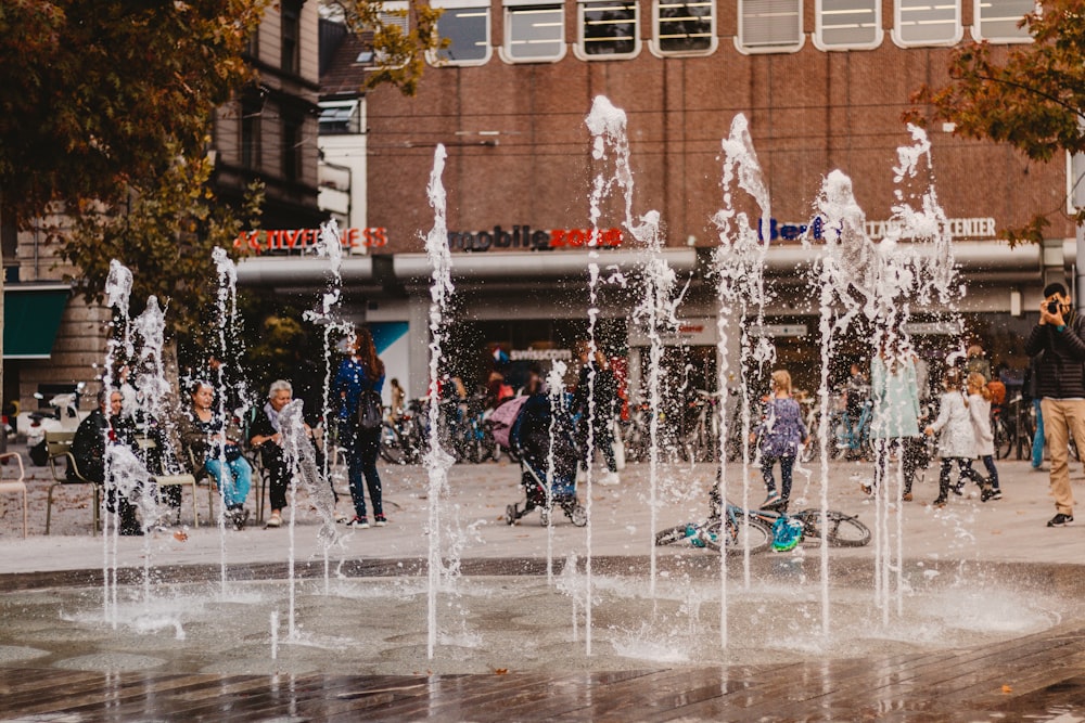 people watching water fountain