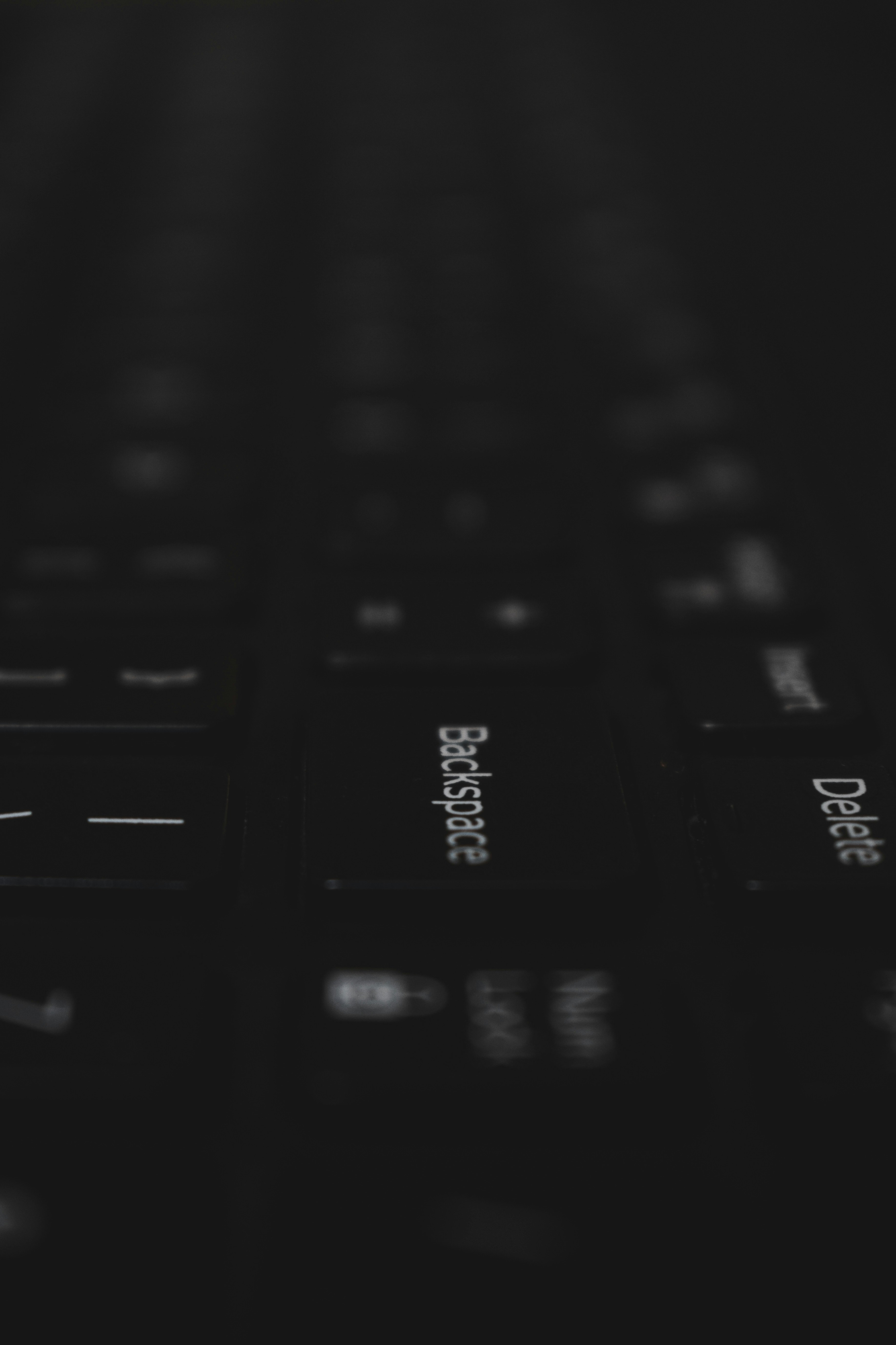 a close up of a black keyboard with white letters