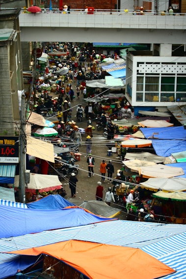 A lively street market in the Hautes-Pyrénées with colorful stalls and locals browsing fresh produce.