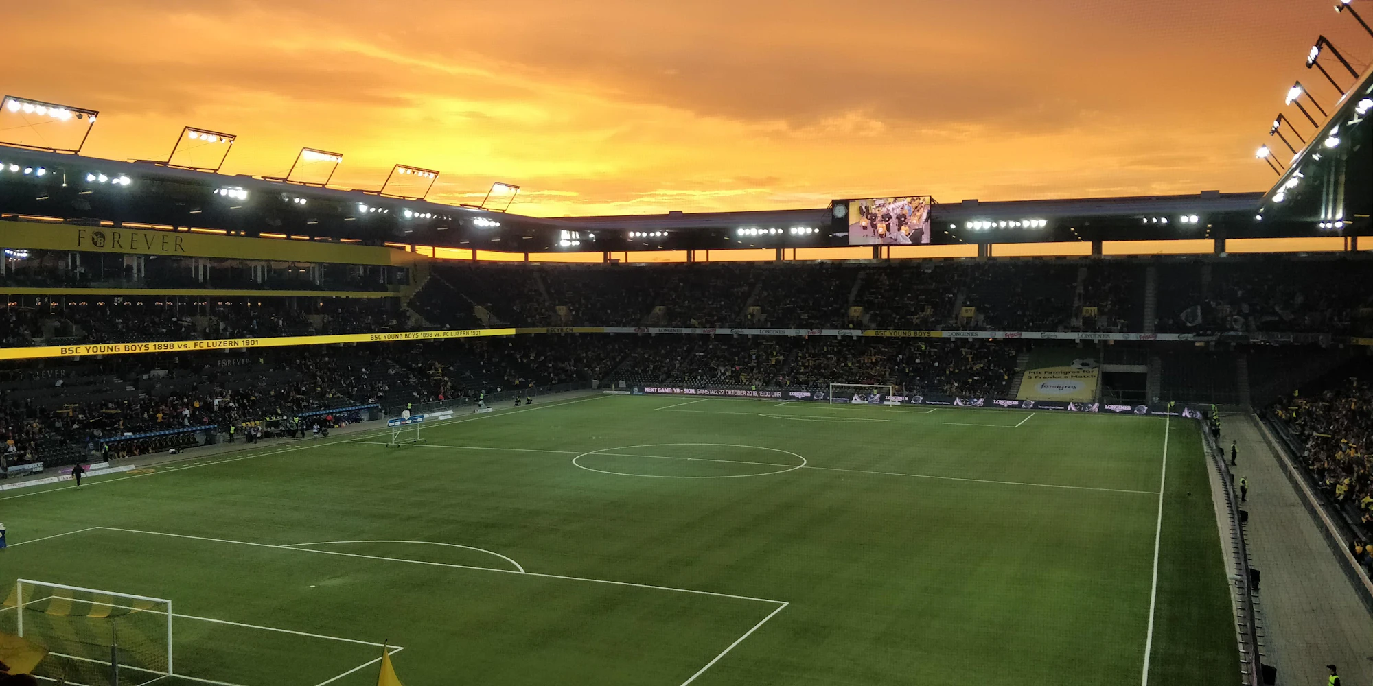 A World Cup stadium glowing at golden hour
