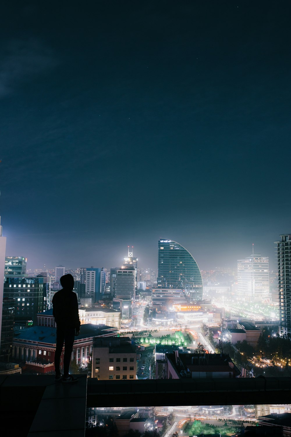 silhouette photo of a person on the top of a building