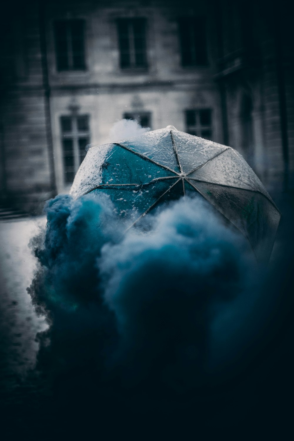 a person holding an umbrella in the rain