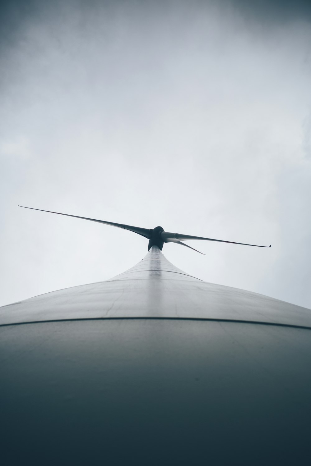 a large airplane flying through a cloudy sky