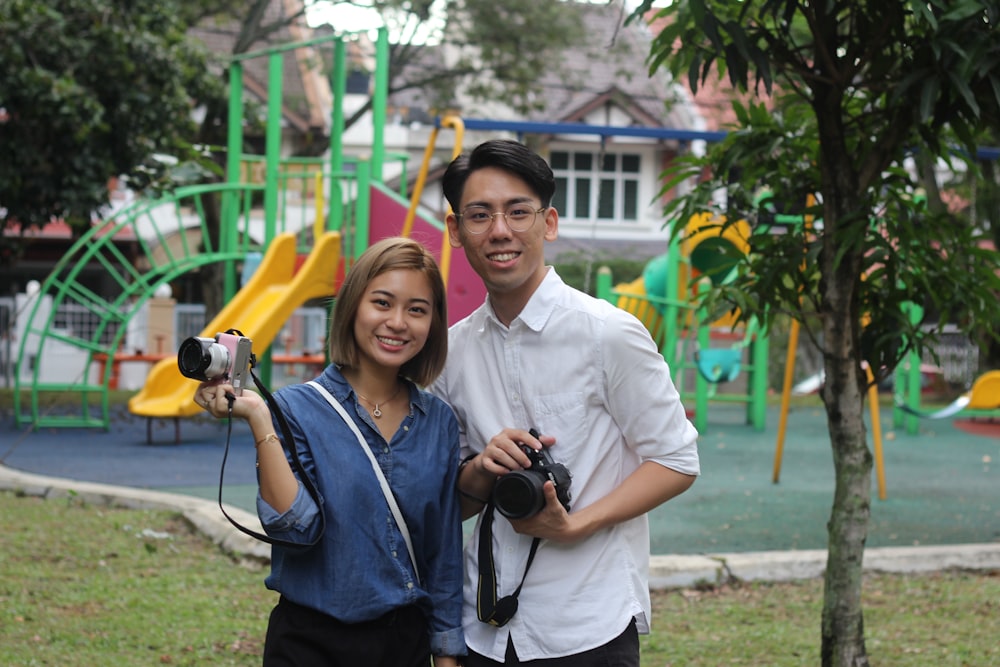 man and woman standing near tree