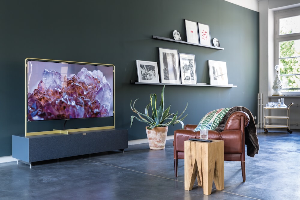 turned-on television in front of leather sofa chair