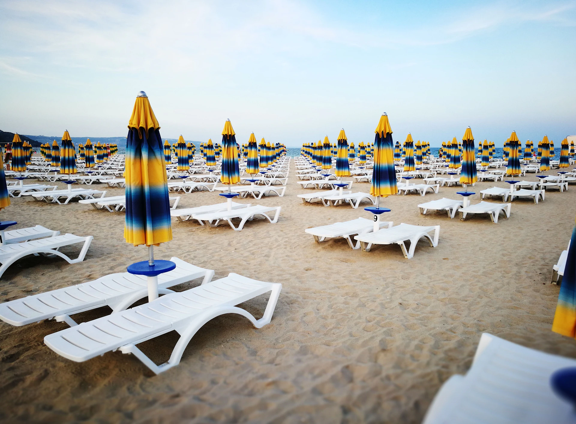white chaise lounges on beach