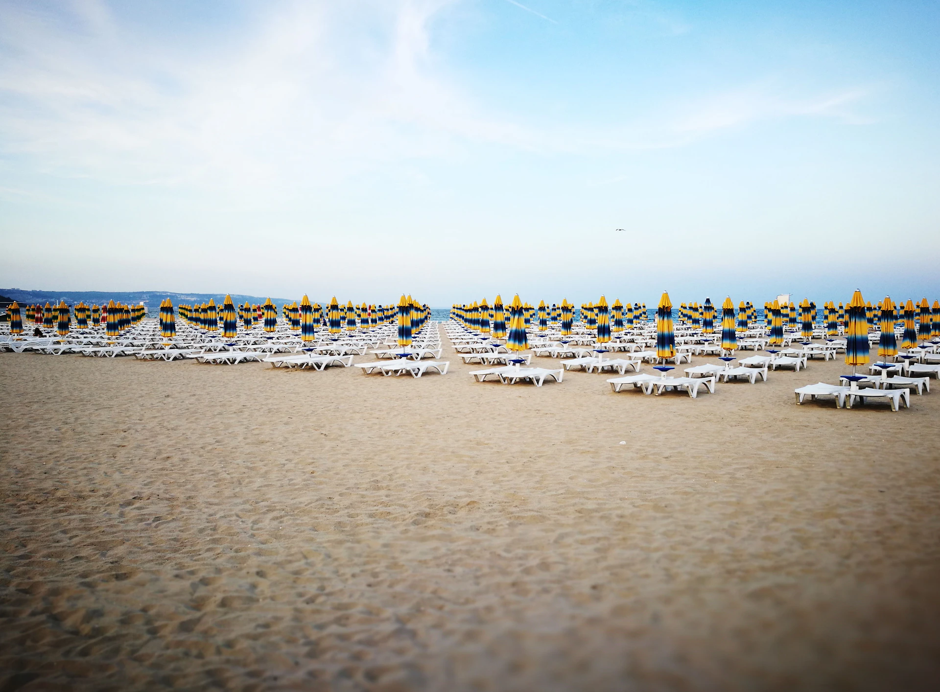 chairs and tables on sand at daytime