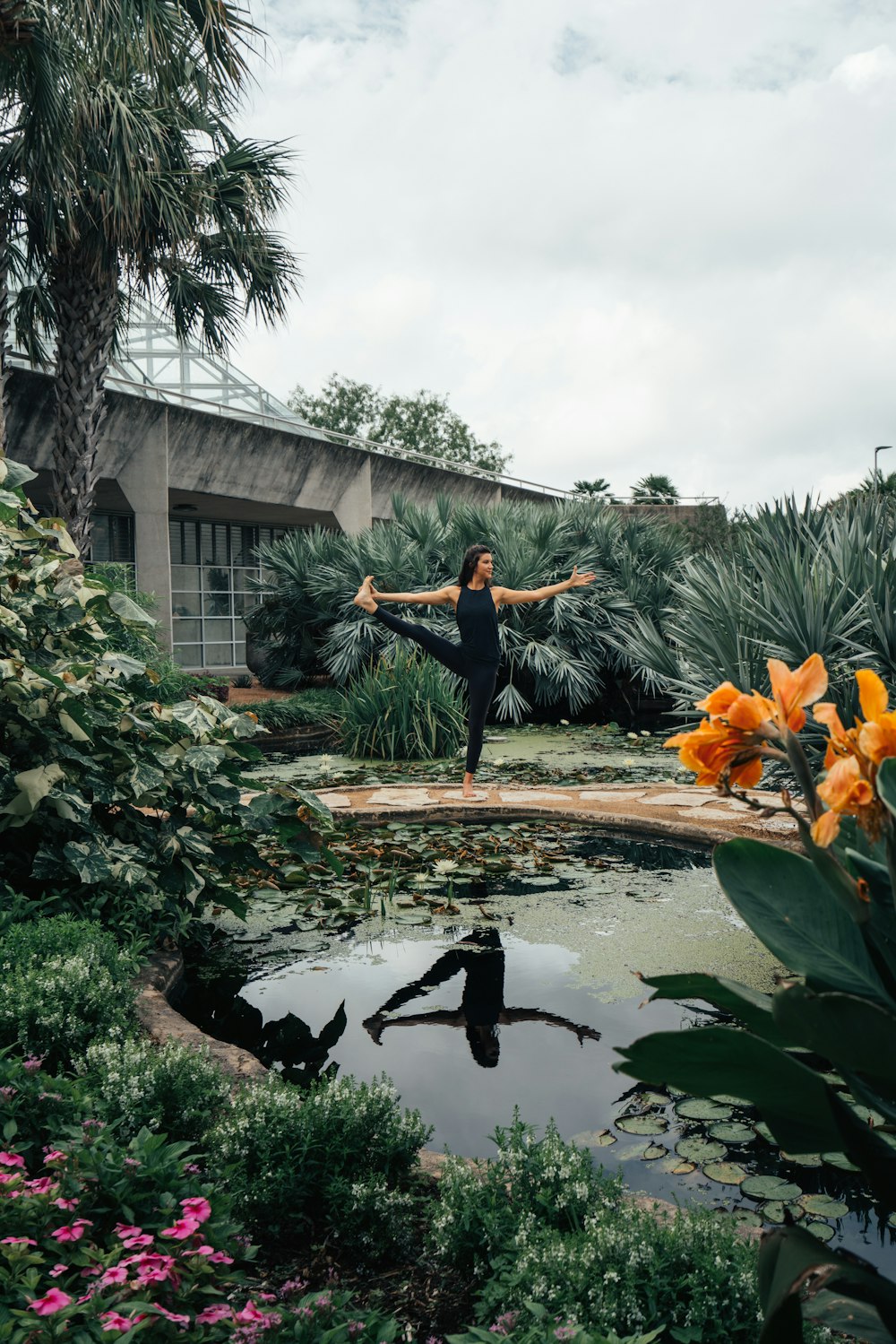 woman standing beside pond