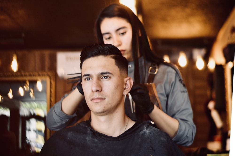 woman holding hair of man