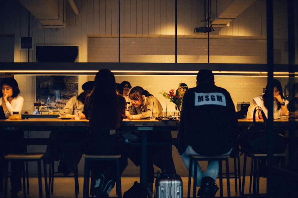 man and woman sitting side by side beside table