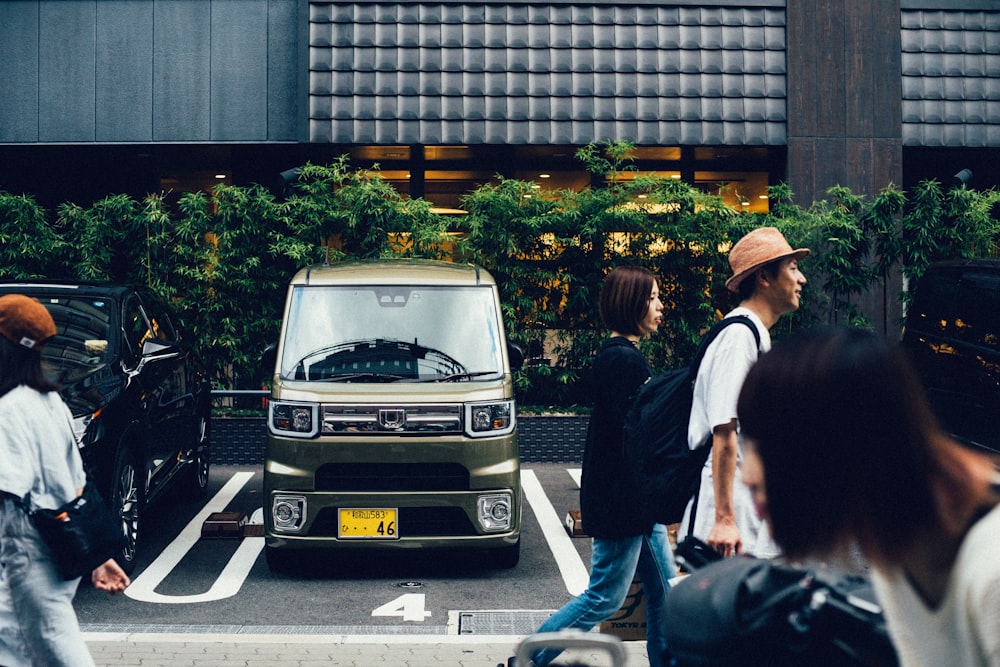 person walking beside gray van