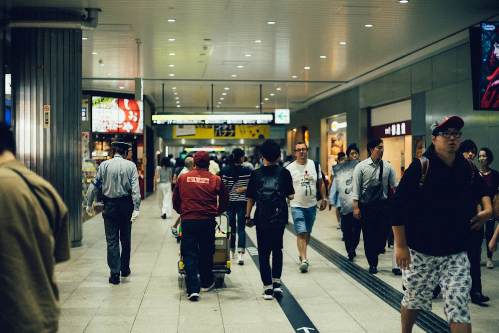 group of people walking inside the buildng