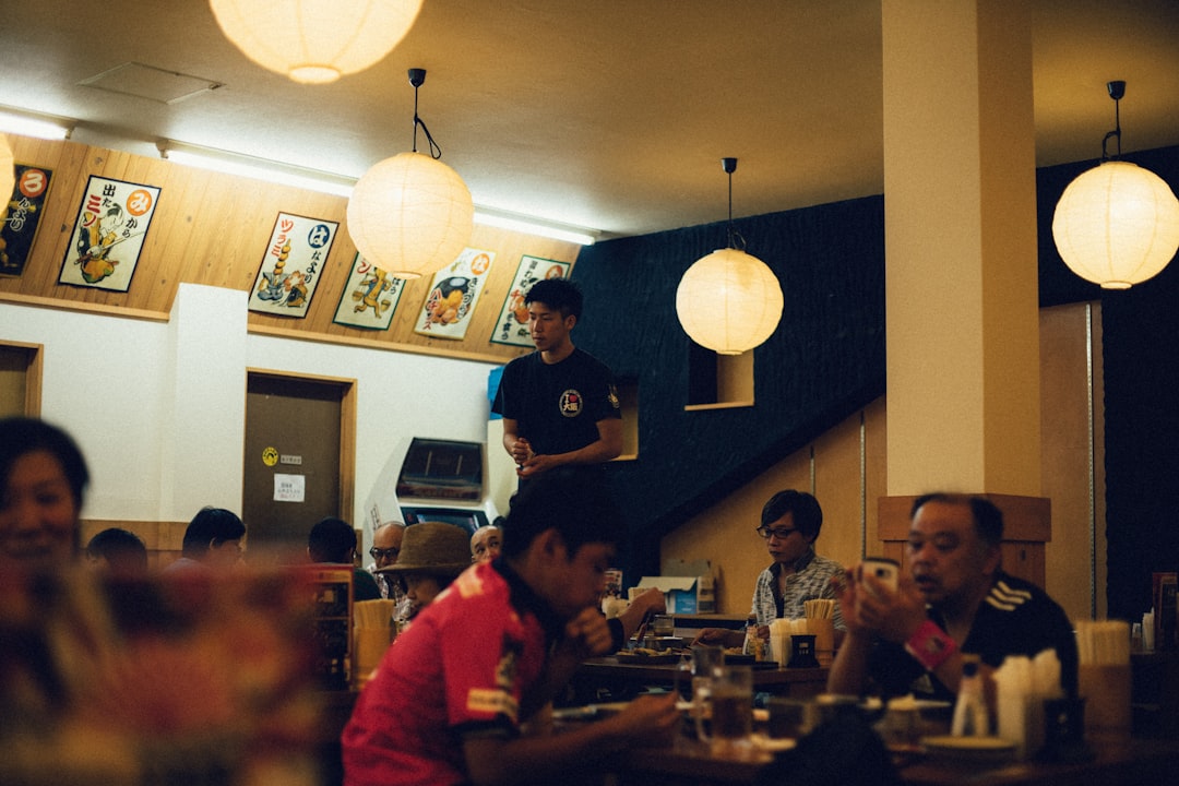 people inside restaurant with pendant lamps,
