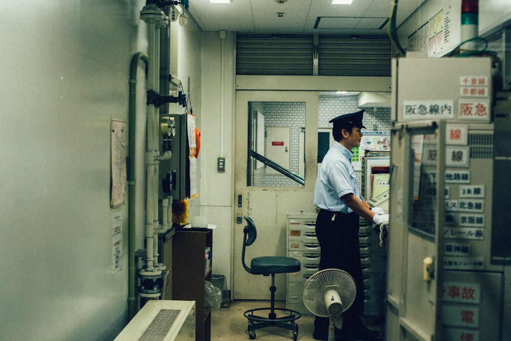 man standing near the control panel