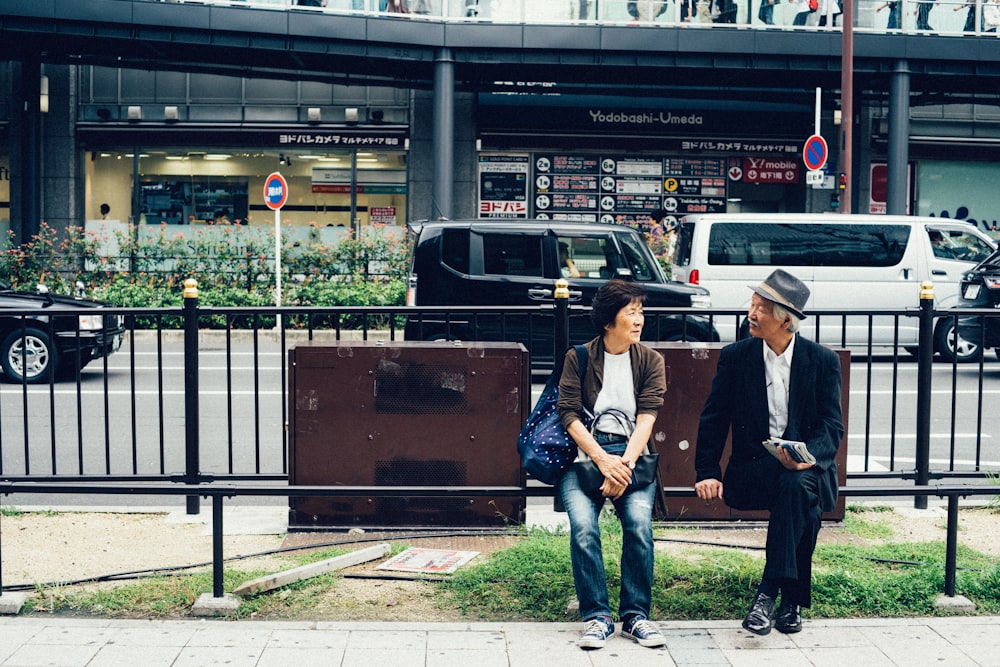 woman and man sitting on bench