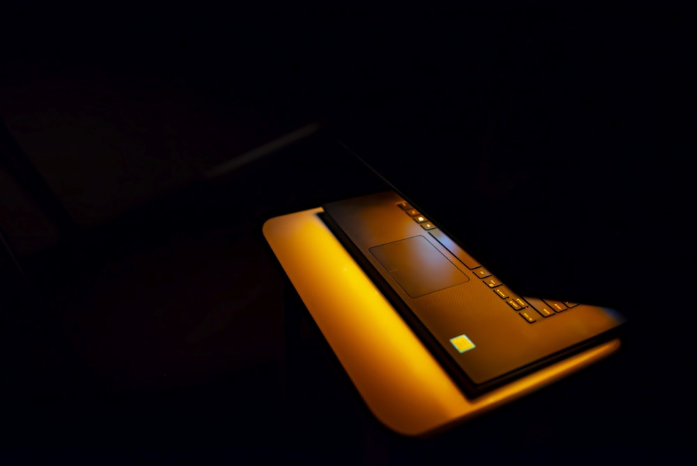 a laptop computer lit up in the dark