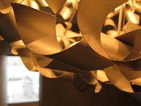 Close-up of a beautifully designed chandelier illuminating a modern dining area.