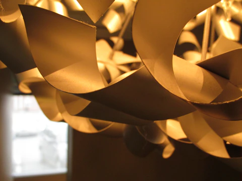 Close-up of a modern chandelier being installed in a stylish home interior
