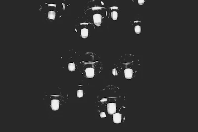 Digital price tags made of delicate curling light strands hovering in midair.