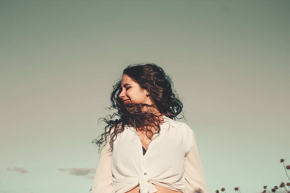 woman wearing white tops under cloudy sky