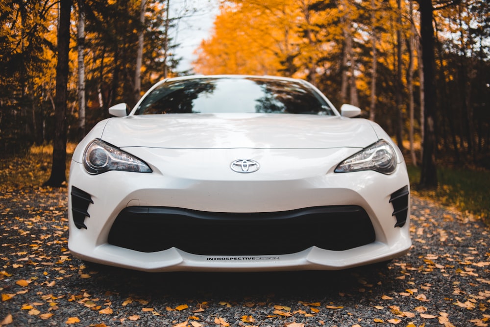 white Toyota coupe parked at road